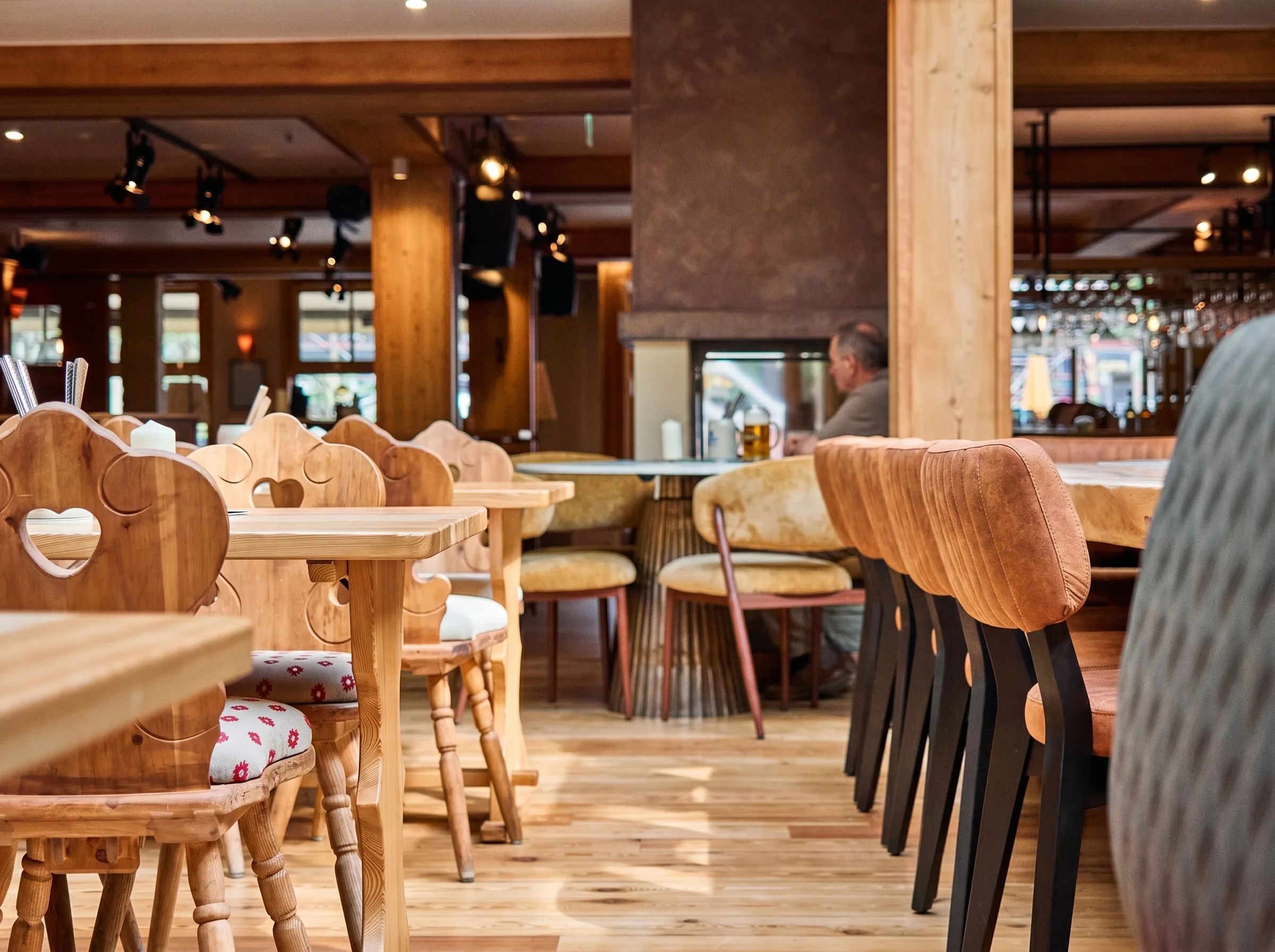 Holztische und herzförmige Stuhllehnen im Wirtshaus Paula